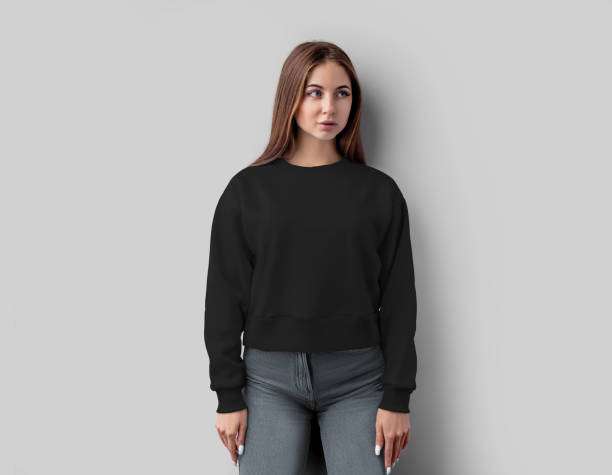 Black cropped sweatshirt template on a beautiful girl, casual textured apparel for design, print, advertising, front view. Black cropped sweatshirt template on a beautiful girl, casual textured apparel for design, print, advertising, front view. Mockup of fashion shirt canvas bella, longsleeve isolated on white background round neckline stock pictures, royalty-free photos & images