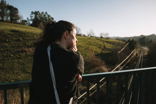 istock Woman leaning on a bridge fence 1466932184