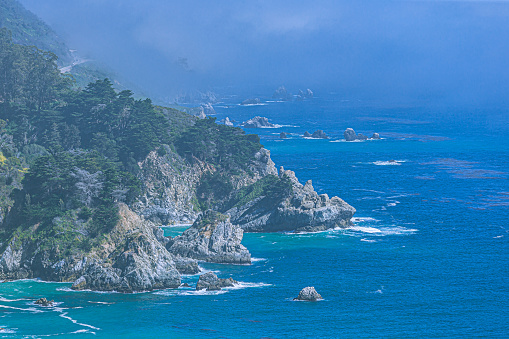 Highway 1 is a narrow, winding road that hugs the cliffs along the coastline, providing stunning views of the Pacific Ocean.