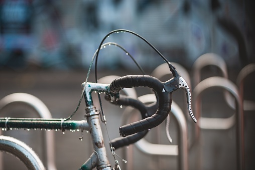A closeup of a wet bicycle's handlebars.