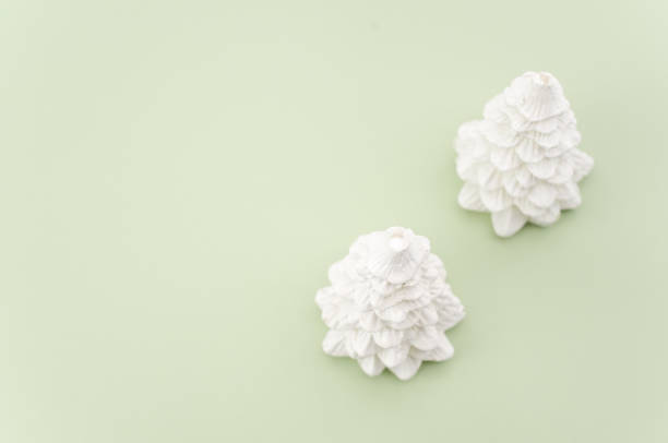 istock decorative white wax fir trees on a white and pastel green background 1466937355