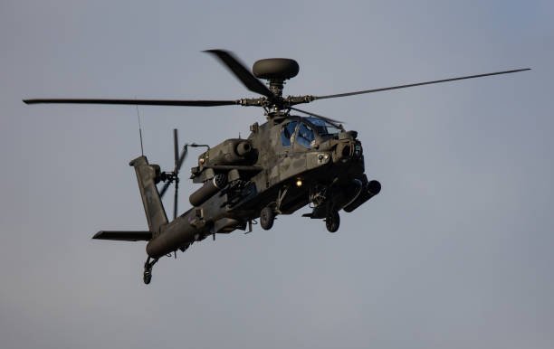 istock Flying military helicopter against a clear blue sky 1466940766