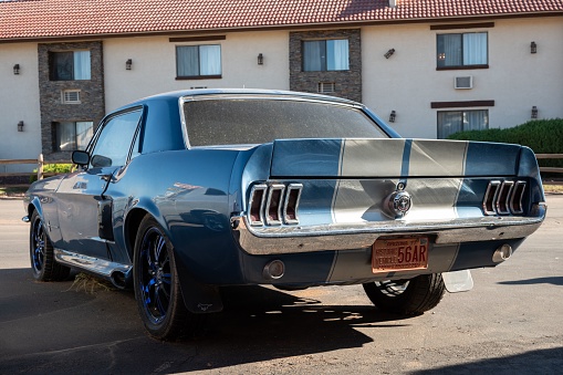 Gand Canyon, United States – October 01, 2022: A detail of a first-generation Ford Mustang with blue color and longitudinal white lines