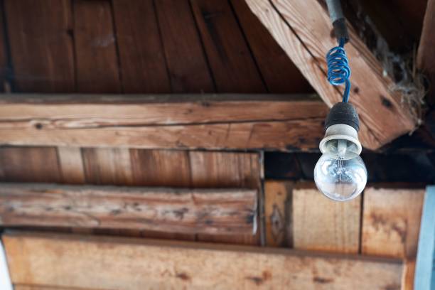 A light bulb hanging from the wooden roof