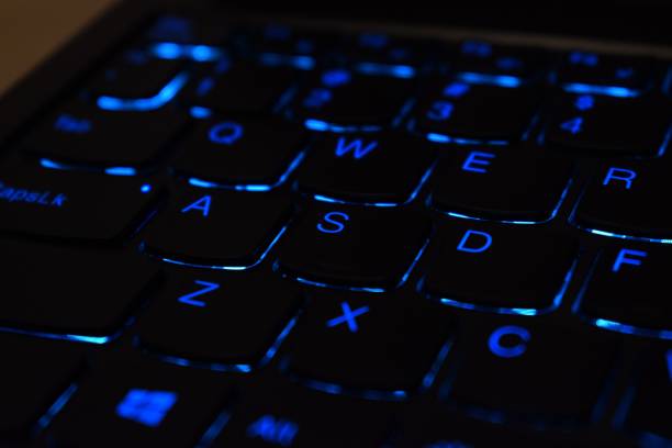 istock Closeup of a black keyboard with blue backlight 1466942855
