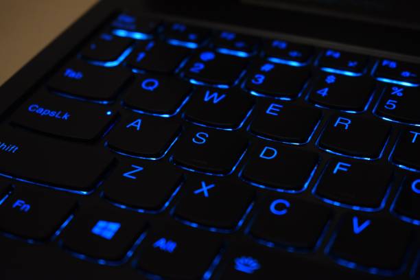 istock Closeup of a black keyboard with blue backlight 1466942859