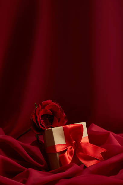 istock Gift Box And Rose Over Red Velvet Background 1466943063
