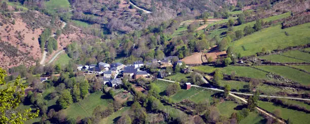 Photo of Village in a green mountain countryside. Slate roofs, meadows and  forest. Pedrafita do Cebreiro, Lugo province,  Galicia, Spain.