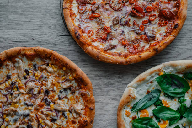 istock Photo of multiple pizzas on table 1466947175