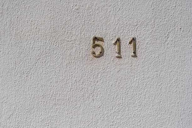istock Metal house number 511 on a white stucco wall background 1466947529