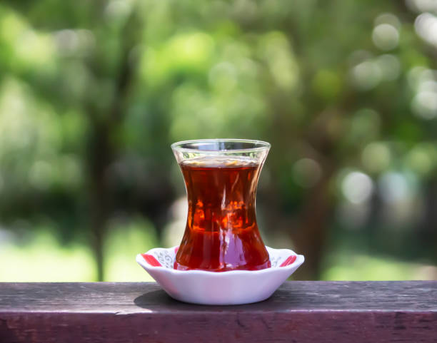 istock turkish tea on the table with blurred nature background. selective focus on glass 1466948549