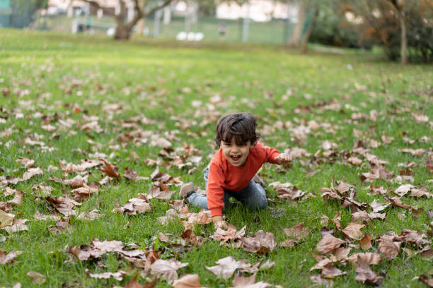 istock Baby boy crawling on grass in public park 1466948580