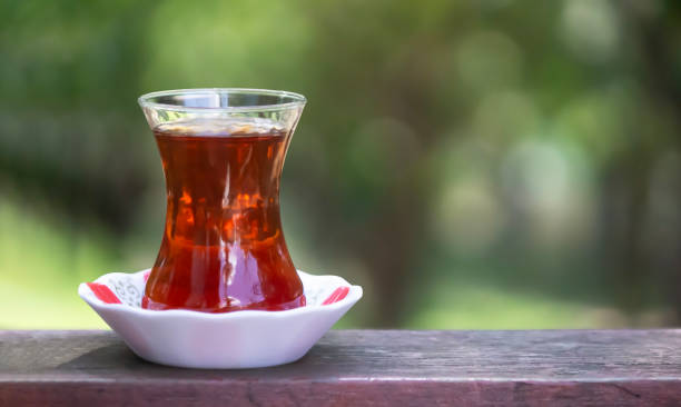 istock turkish tea on the table with blurred nature background. selective focus on glass 1466948610