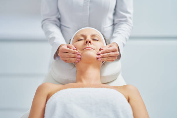 istock Young nice woman having face massage in spa 1466950180
