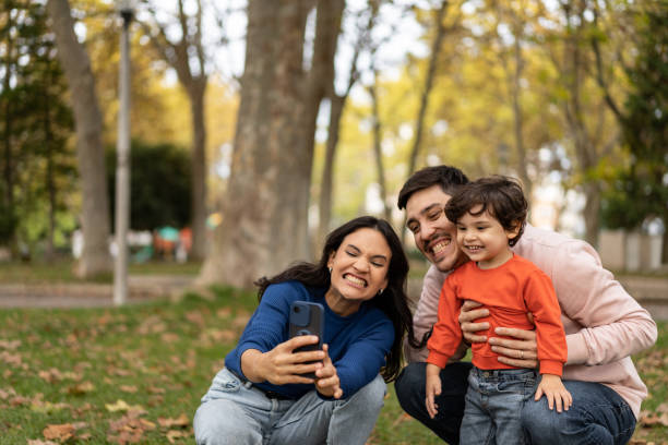 istock Family grimacing taking a selfie in public park 1466950447