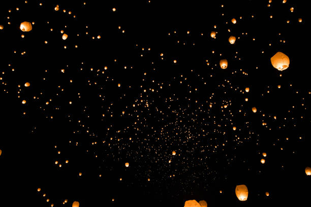 istock Low angle shot of a black sky with floating orange lanterns 1466950458