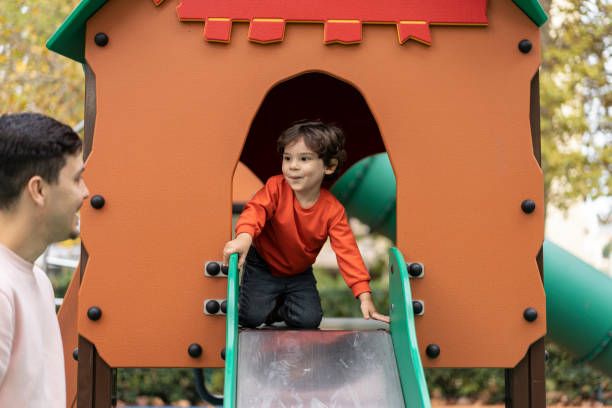 istock Baby boy on playground slide 1466950471