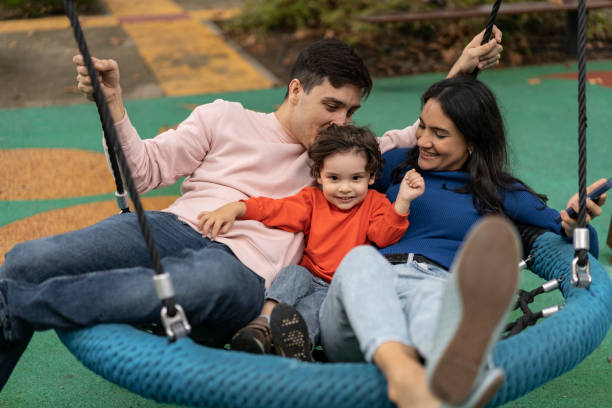 istock People on public park swing 1466950640