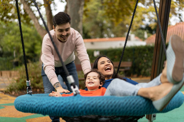 istock People on public park swing 1466950641