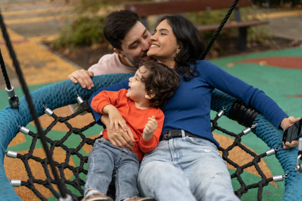 istock People on public park swing 1466950734