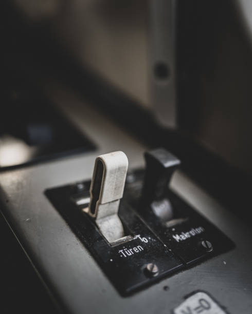 istock Vertical selective focus shot of the button with german word for opening and closing doors of train 1466950965