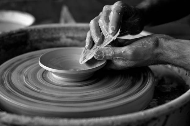 istock Grayscale closeup shot of elder hands making pottery 1466951363