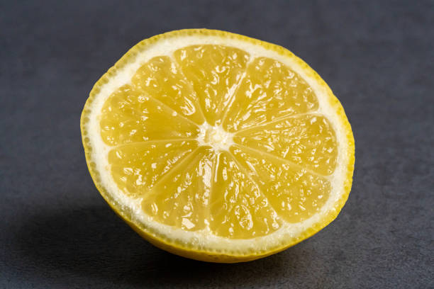 istock Closeup of a Fresh yellow sliced lemon isolate on a dark background 1466951542