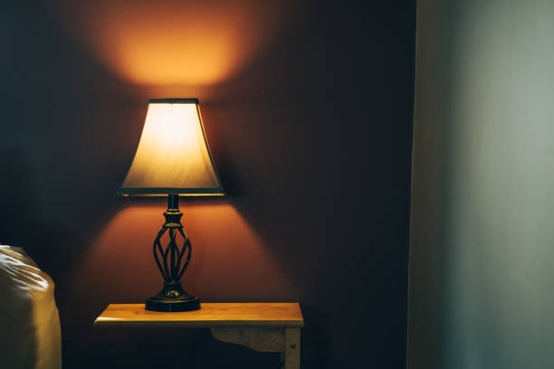istock Table lamp with orange light on a bedroom 1466952062