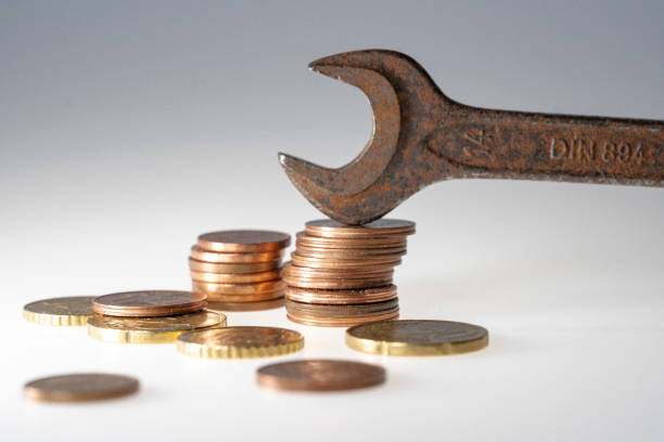 istock Some Euro Cent Coins and an open-end wrench tool 1466955307