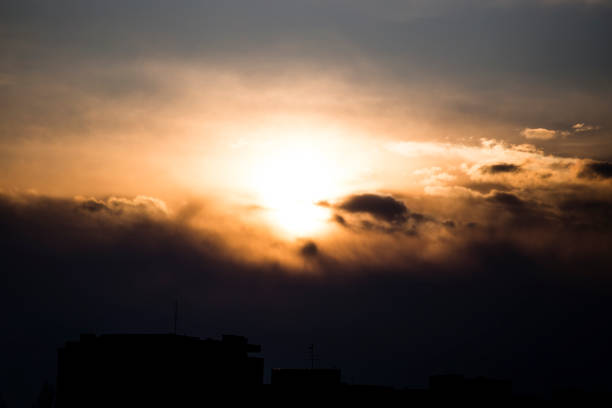 The sky at the beautiful sunset with sun covered with clouds