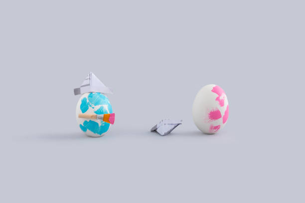 istock Two painted eggs with paper hats isolated on a white background with free space for text 1466962230