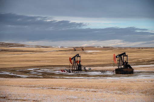 Pump jacks working in the oilfields of Alberta, Canada.
