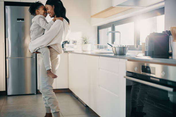 istock Single mother carrying her daughter in the kitchen 1466962727