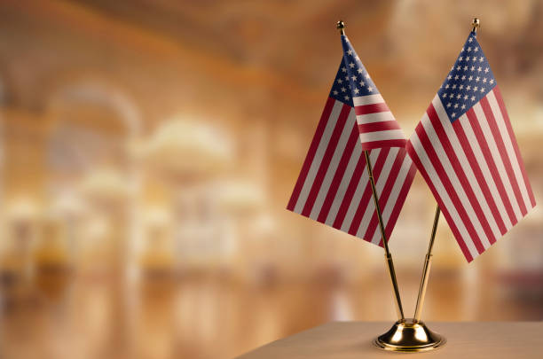 istock Small flags of the USA on an abstract blurry background 1466963465