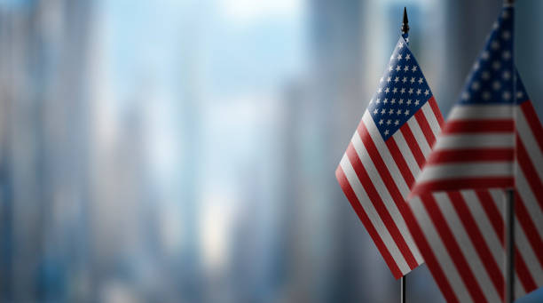 istock Small flags of the USA on an abstract blurry background 1466963564