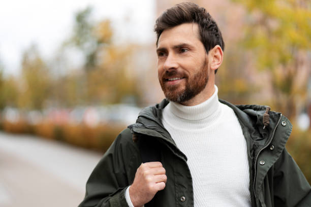 istock Happy bearded man is standing outdoors and laughing while looking away. 1466967586