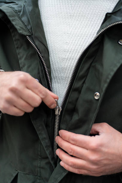 istock Young man wearing a jacket, man holding a jacket zip. 1466967971
