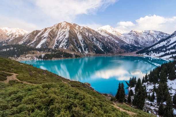 Scenic view of the Big Almaty Lake with Tianshan Mountains in Kazakhstan near the city of Almaty A scenic view of the Big Almaty Lake with Tianshan Mountains in Kazakhstan near the city of Almaty kazakhstan stock pictures, royalty-free photos & images