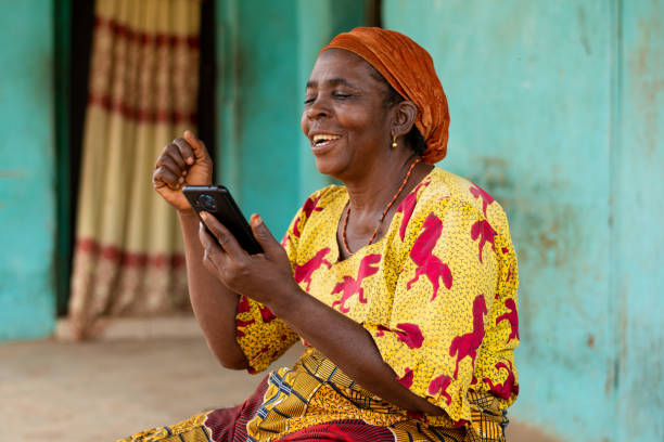 istock Beautiful elderly African woman taking a video call using her smartphone 1466968731