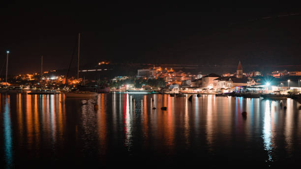 istock Coastal buildings reflected in the water at night 1466972438