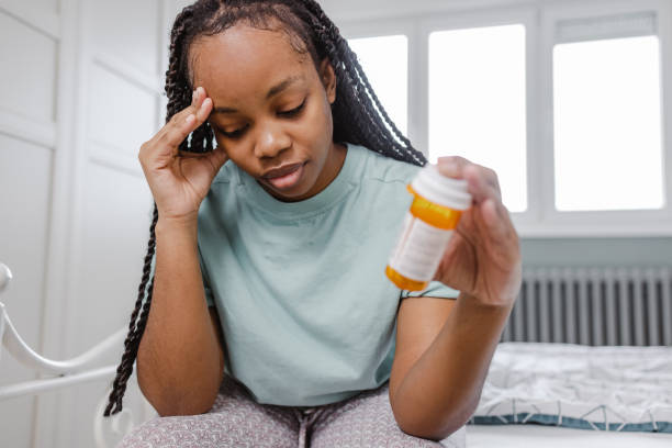 Young woman feels drug side effects stock photo