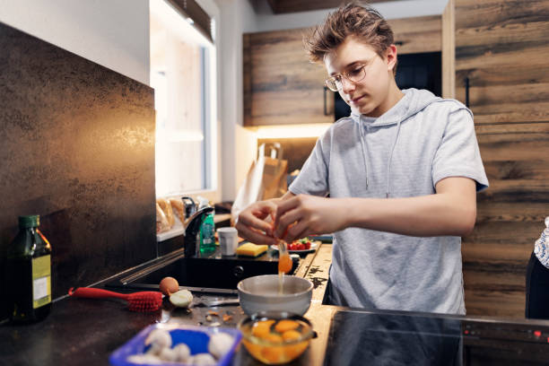 istock Teenage boy preparing breakfast 1466975531