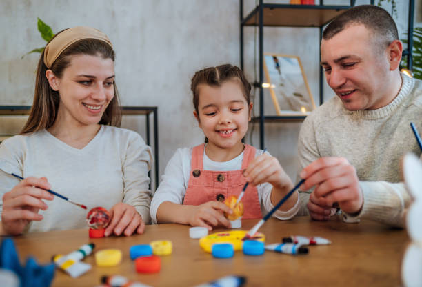 istock Family painting eggs for Easter 1466976889