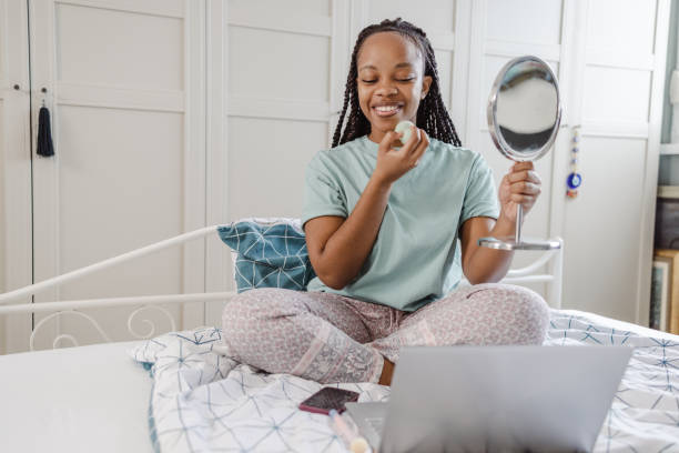 istock African-American young woman watching online beauty tutorial 1466976906