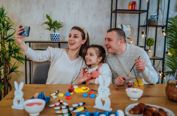 istock Family taking a selfie while painting Easter eggs 1466976988