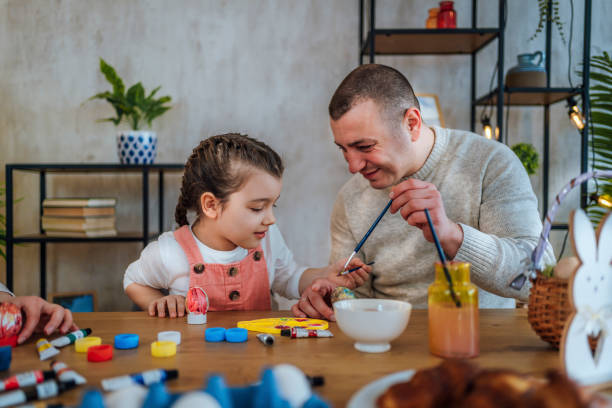 istock Father and daughter painting eggs for Easter 1466978049