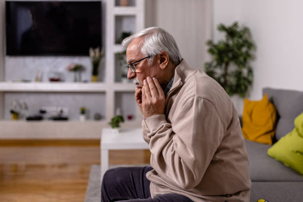 istock A senior grey-haired man has chronic everyday problems with his teeth. Dental health issues. 1466979060
