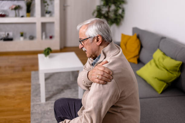 istock A senior man is experiencing hard everyday pain in his shoulders. 1466979332