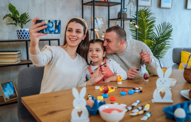 istock Family taking a selfie while painting Easter eggs 1466979391