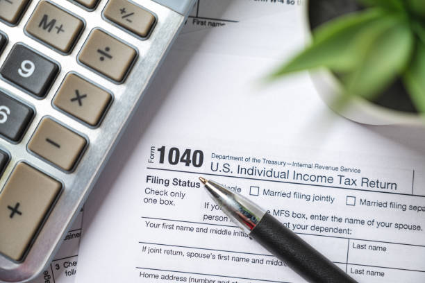 istock Financial time tax return forms with pen and calculator 1466979629